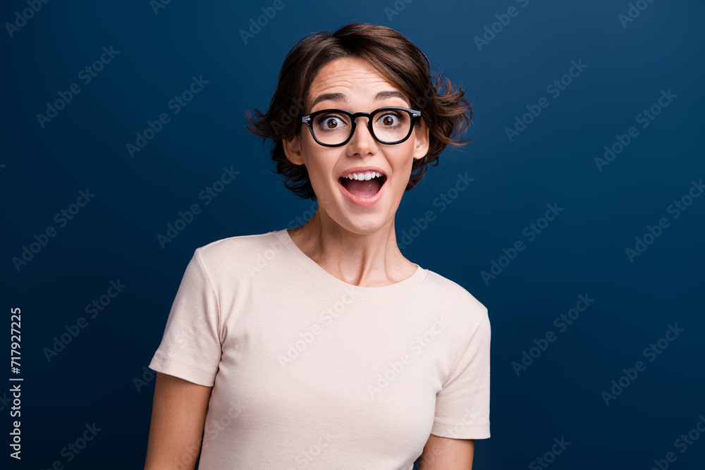 Portrait of funny excited business lady wearing new computer specs perfect eyesight isolated dark blue color background