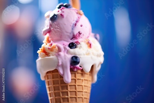 brightly lit blueberry ice cream scoop in cone close-up