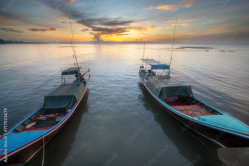 traditional long tail boats with sunrise background in southern Thailand