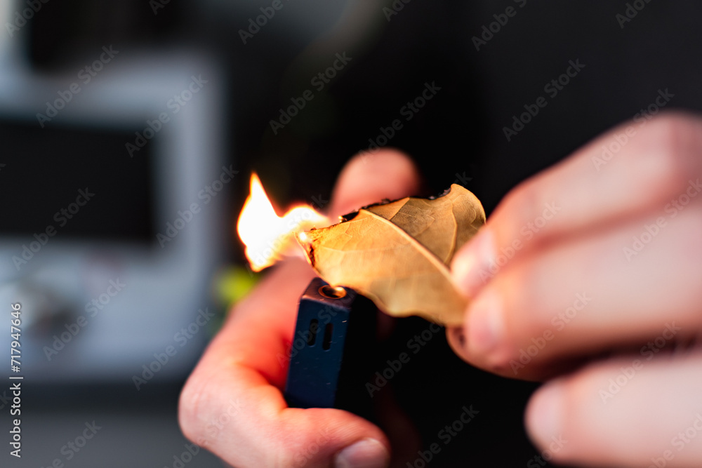 Person who burn bay leaves to bring serenity, reduce anxiety, relieve