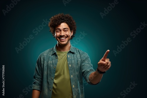 Portrait of a young latino man isolated on teal background pointing to the side. Generative AI.