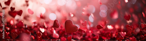 Bright red hearts confetti on blurred background