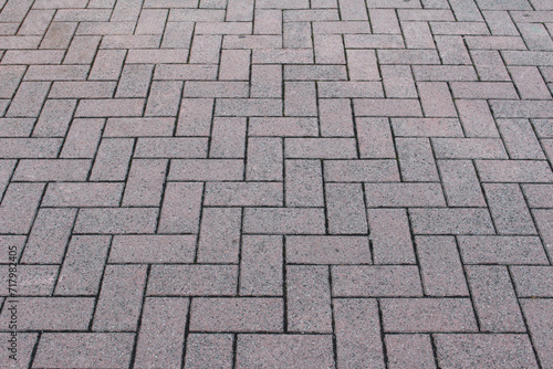 Texture of square cobblestone. Pattern of sidewalk tiles in the street.