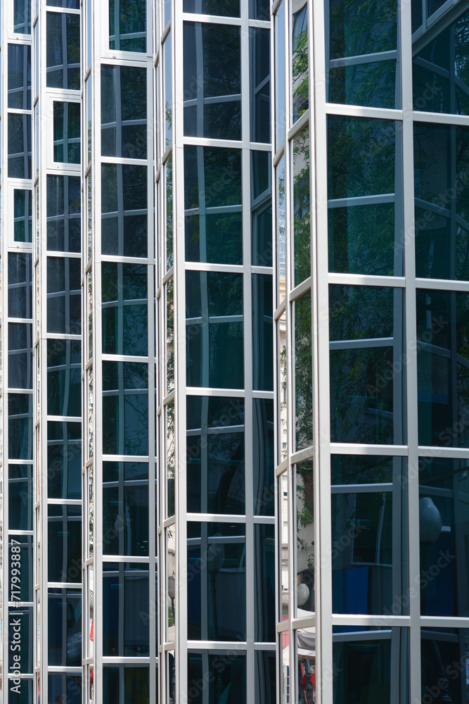 Detail of the glass window grid on a building with reflections - architectural abstraction Detail of the glass window grid on a building with reflections - architectural abstraction