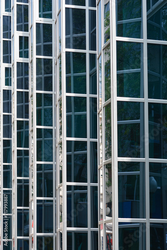 Detail of the glass window grid on a building with reflections - architectural abstraction