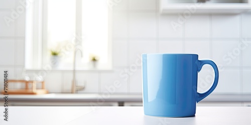 Blurred white background featuring a blue mug in a kitchen