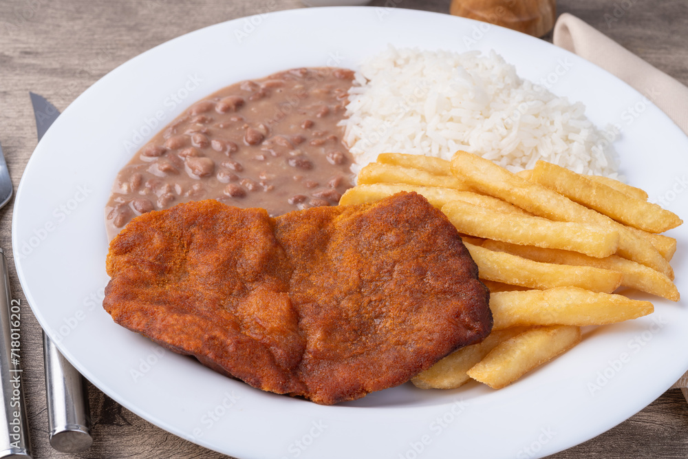 Milanese beef, rice, beans and french fries. Typical brazilian executive dish Milanese beef, rice, beans and french fries. Typical brazilian executive dish
