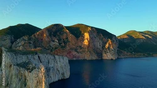 Porto Flavia scenic landscape at sunset, Natural limestone rocky cliffs at the coast of Masua, South Sardinia, Italy photo