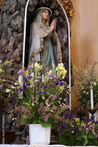 a large bouquet of meadow flowers in a vase in a church