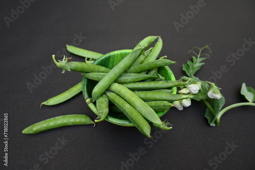Fresh Green peas on black background. There is a lot of vitamins  and Minerals in it. The pea is most commonly the small spherical seed or the seed. Popular vegetable of all over world. 