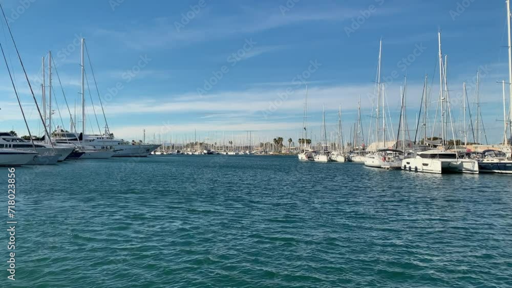 Navigation channel with docks full of sailboats and yachts in the port of Valencia, Spain. Navigation channel with docks full of sailboats and yachts in the port of Valencia, Spain.
