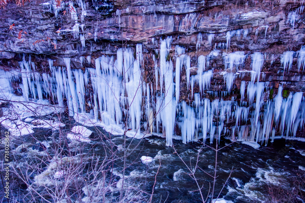 Beautiful winter scene featuring a cliff adorned with sharp icicles