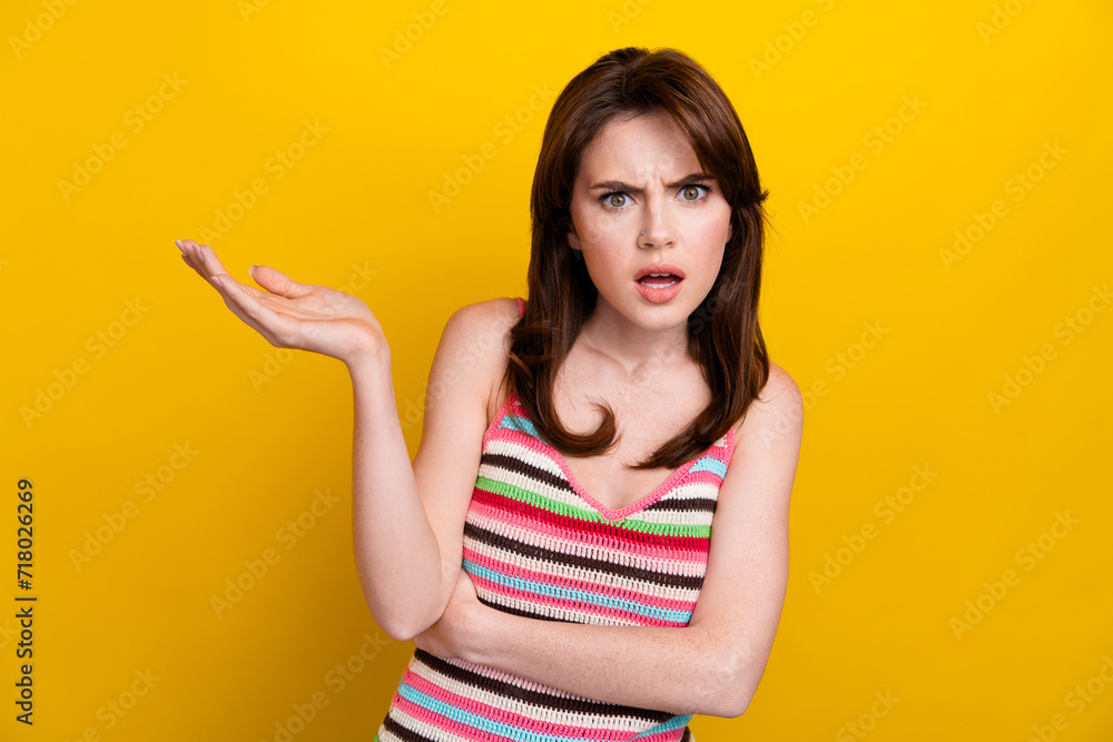 Portrait of dissatisfied angry woman with nose piercing dressed knitwear top raising palm argue isolated on yellow color background Portrait of dissatisfied angry woman with nose piercing dressed knitwear top raising palm argue isolated on yellow color background
