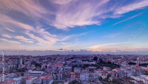 Panoramic aerial view over Rooftops of Porto's old town on a warm spring evening timelapse during sunset time with cloudy colorful sky, Porto, Portugal photo