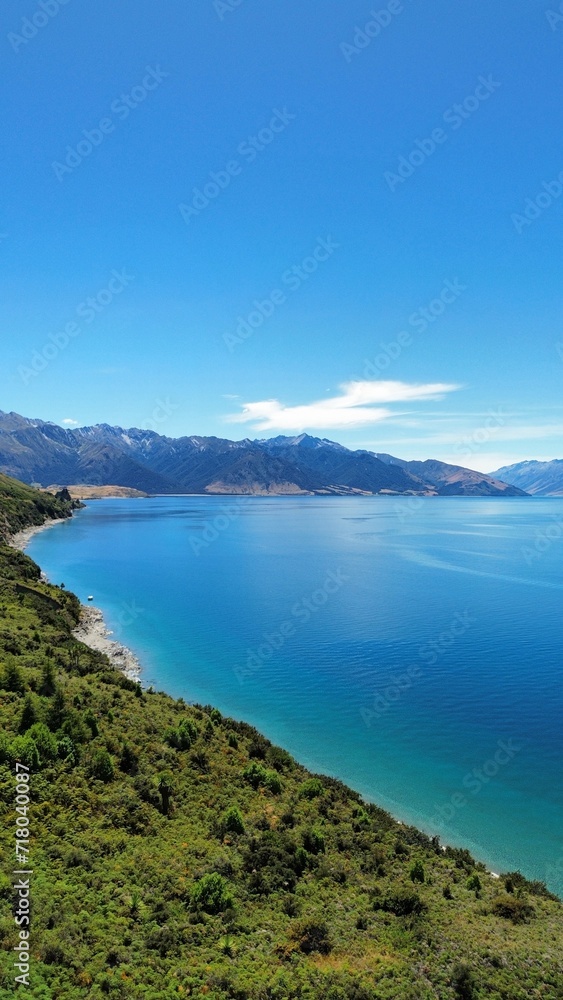 Aerial view of Lake Hawea surrounded by lush greenery. New Zealand