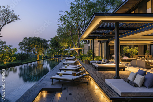 a lavish side outside garden at morning, with a teak hardwood deck and a black pergola. Scene in the evening with couches and lounge chairs by the pool