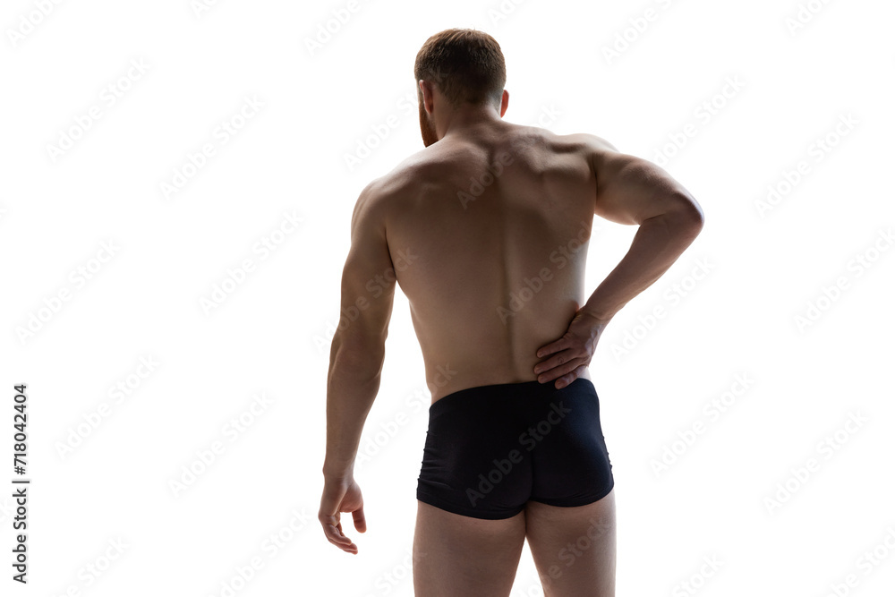 Scapula injury, loin inflammation, back pain. Fit and healthy man put hand on hip against white studio background. Concept of beauty care, male health, masculinity, fitness. Ad