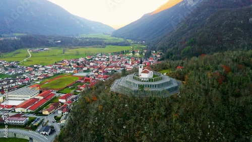 Aerial 4K drone footage captures the majestic Church of Saint Anthony, Kobarid- Slovenia. This landmark is dedicated to the memory of the fallen soldiers from World War I. Filmed in late autumn. photo