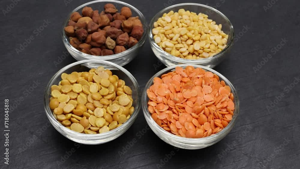 variety of lentils pulses red masoor mung dal yellow split chickpeas pigeon peas in mini glass bowl on black slate background move pan keep variety of lentils pulses red masoor mung dal yellow split chickpeas pigeon peas in mini glass bowl on black slate background move pan keep
