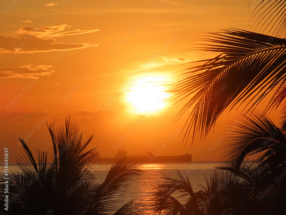 sunset landscape on the coast with boats, sea, marina, port, colorful clouds, sand, beach