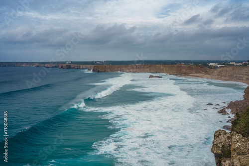 Stunning windswept cliffs, Atlantic ocean, and cloudy sky.  View from Sagres lighthouse, Portugal