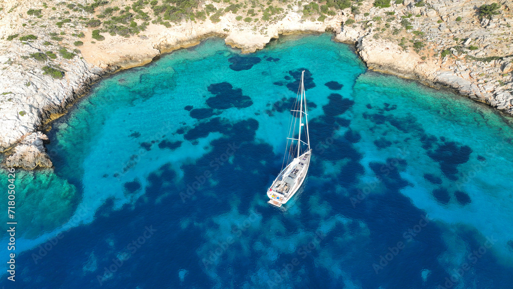 Aerial drone photo of luxury sail boat anchored in paradise bay of Ornos in island of Mykonos, Cyclades, Greece