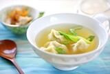 wonton soup with bok choy in a clear broth