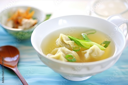 wonton soup with bok choy in a clear broth photo