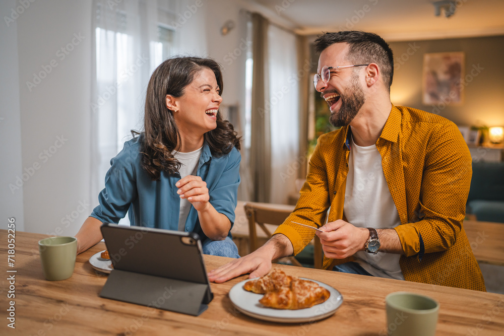 adult happy couple man and woman shopping online hold credit card adult happy couple man and woman shopping online hold credit card