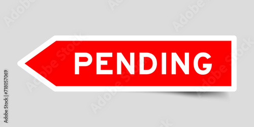 Red color arrow shape sticker label with word pending on gray background