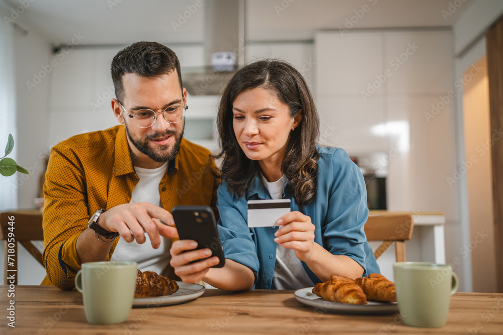 adult happy couple man and woman shopping online hold credit card adult happy couple man and woman shopping online hold credit card