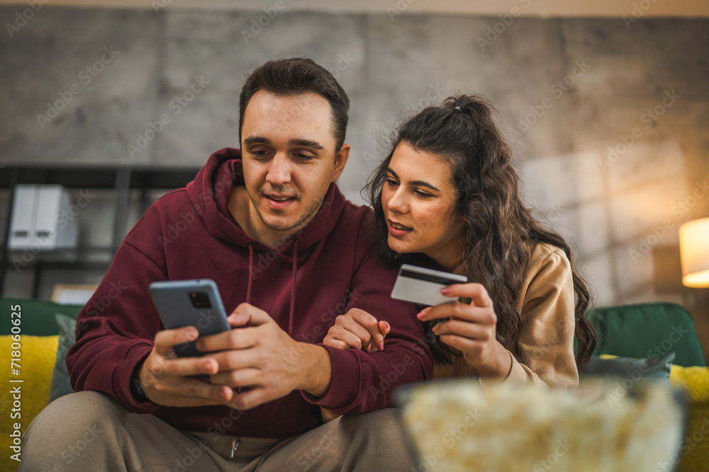 adult happy couple man and woman shopping online hold credit card adult happy couple man and woman shopping online hold credit card