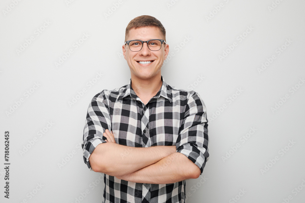 Portrait man smiling joyfully with arms crossed on chest isolated on white studio background, advertising banner. Portrait man smiling joyfully with arms crossed on chest isolated on white studio background, advertising banner.