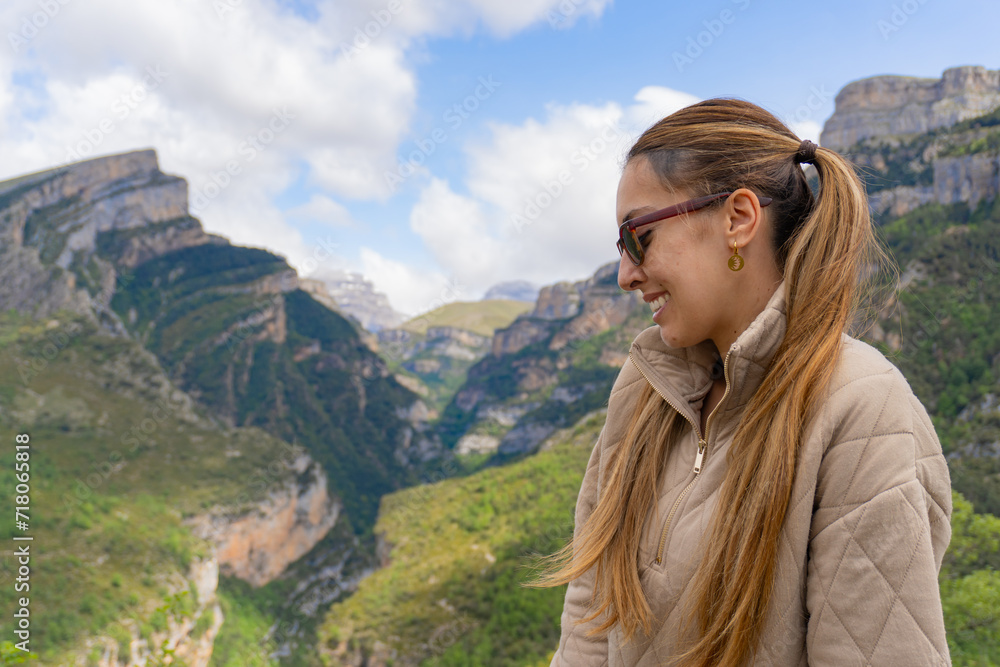 Woman with sunglasses and pigtails smiles sideways in Añisclo C