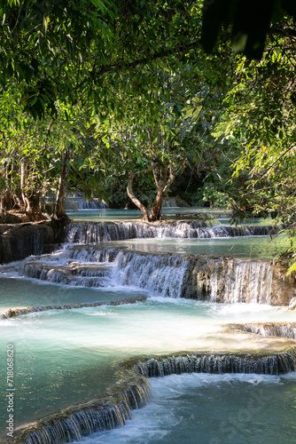 Blue water tropical waterfalls surrounded by lush vegetation © Cavan