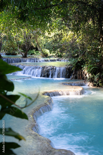 Blue water tropical waterfalls surrounded by lush vegetation © Cavan