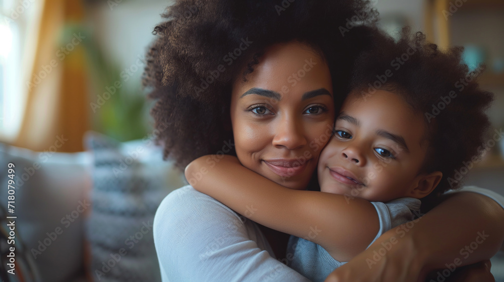 Celebrating Mother's Day: African American Mom Hugging Young Daughter Celebrating Mother's Day: African American Mom Hugging Young Daughter