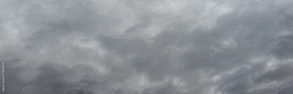 Fototapeta premium The dark stormy sky is covered with dense gray clouds