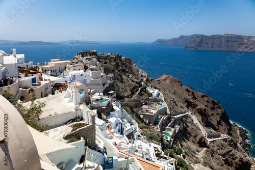 Santorini, Greece - 05 28 2023: Fira's caldera's view in the morning. Stacked white washed cave houses with infinity pools. 