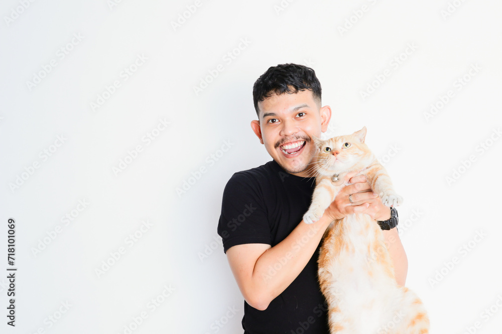a young asian man hugging a tabby cat, on a white background a young asian man hugging a tabby cat, on a white background