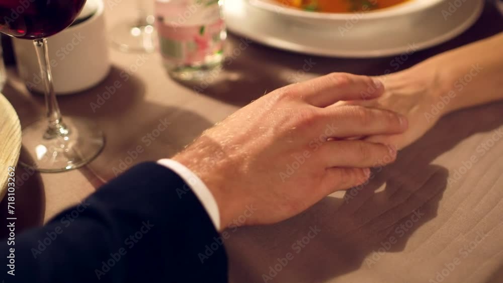 Dolly Close Up Shot of Man Taking Woman's Hand and Holding it on a Chic Restaurant Table Dolly Close Up Shot of Man Taking Woman's Hand and Holding it on a Chic Restaurant Table
