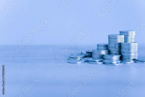Piles of Silver money coins and a financial growth graph