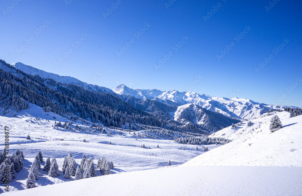 Fantastic winter landscape after a snowfall in the mountains not far from Almaty. Kok-zhailau plateau in the snow, a popular tourist route in the mountains.