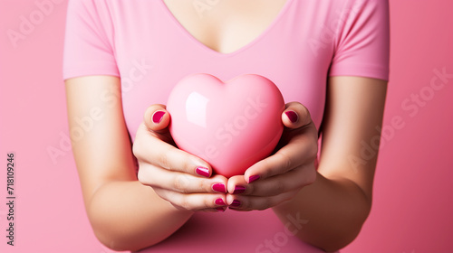 Heart on hand with pink background