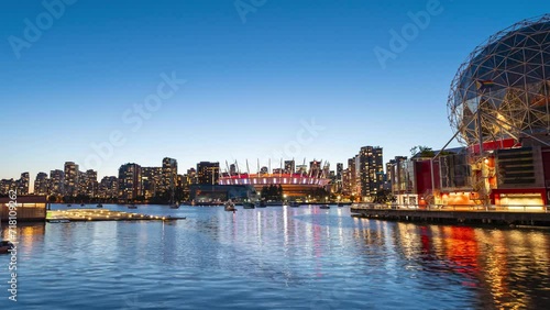 A 4k long exposure time lapse during blue hour of the Vancouver Skyline from False Creek with the Science World Building and the BC Place Stadium illuminated. photo
