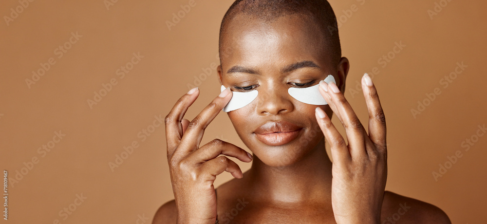 Naklejka premium Face, beauty or happy black woman with eye patch for skincare or wellness isolated on brown background. Studio, smile or model with facial collagen pads, dermatology product or anti aging cosmetics
