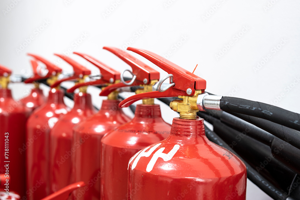 Naklejka premium A fire extinguisher in the production room. Fire extinguishing system. A hand-held fire extinguisher in case of fire.