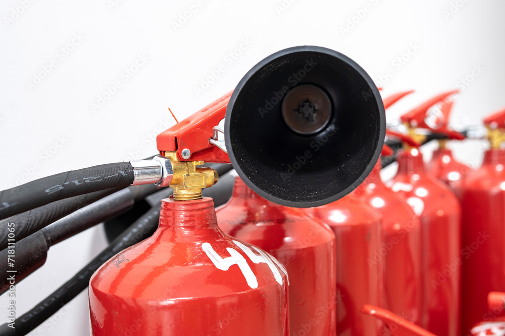 A fire extinguisher in the production room. Fire extinguishing system. A hand-held fire extinguisher in case of fire.