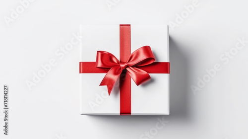 White gift box with red ribbon bow on white background