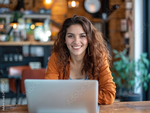Happy beautiful girl using laptop in office